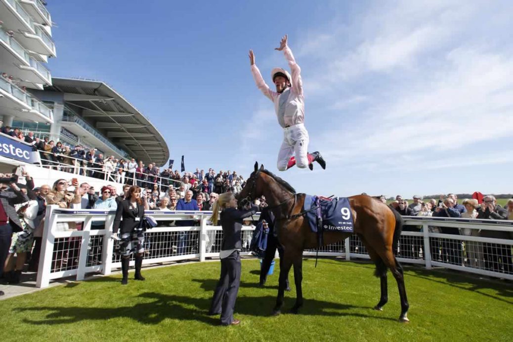 Frankie Dettori does his famous leap off his horse after winning at Epsom Racecourse